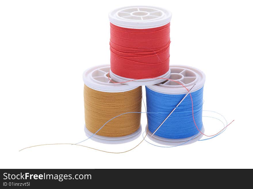 Three plastic reels with sewing thread. Three plastic reels with sewing thread