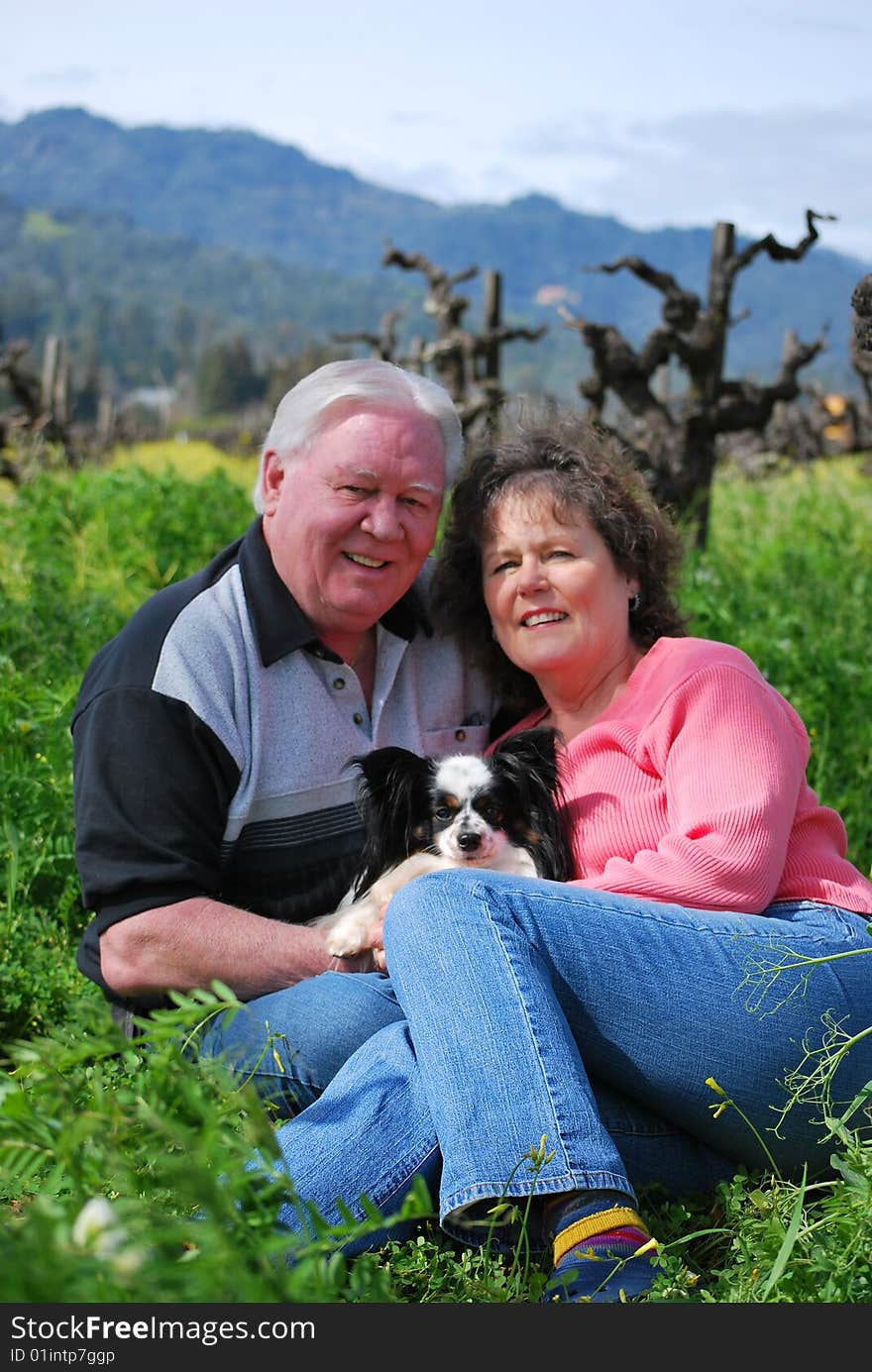 Happy Couple Posing With Their Dog