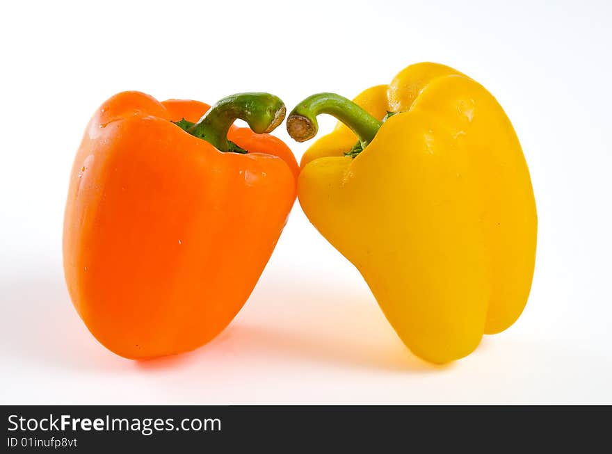 Two bell peppers leaning close together