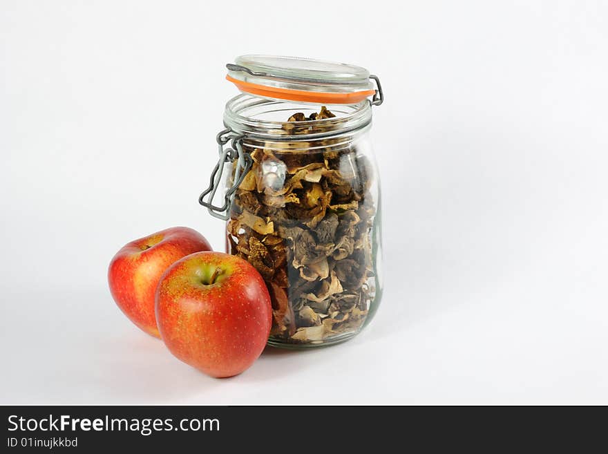 Jar full of wild mushrooms and red apples. Jar full of wild mushrooms and red apples