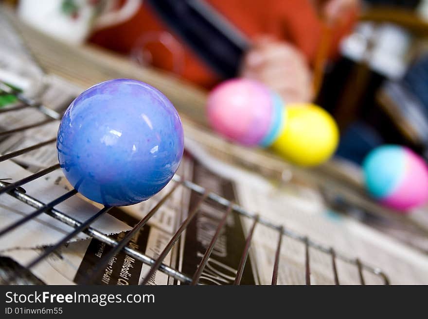 A blue Easter egg dries after painting. A blue Easter egg dries after painting