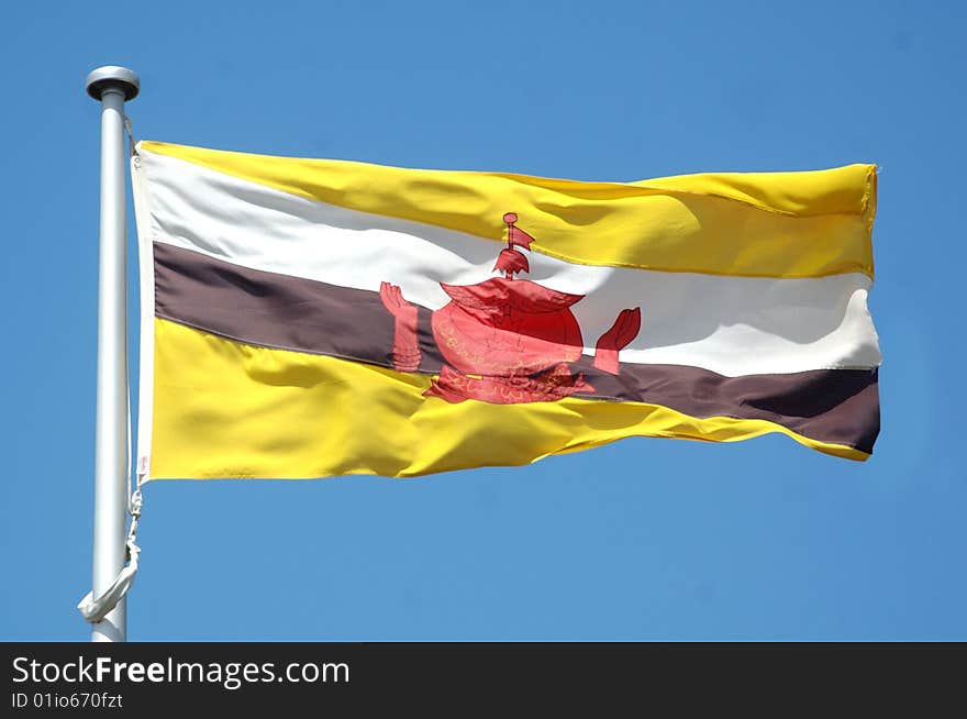 Flag of Brunei against blue sky