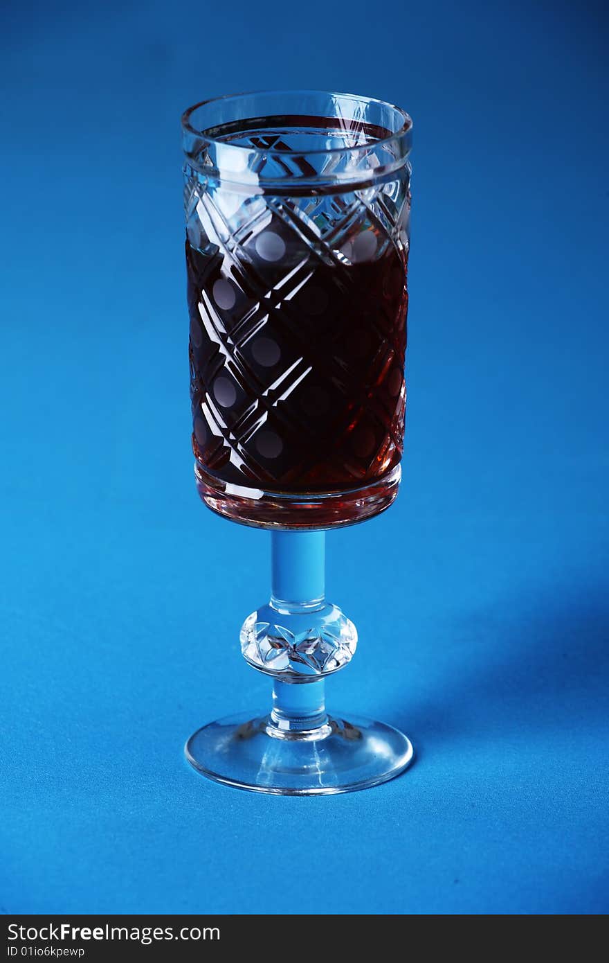 Crystal carved glass with red wine. Crystal carved glass with red wine