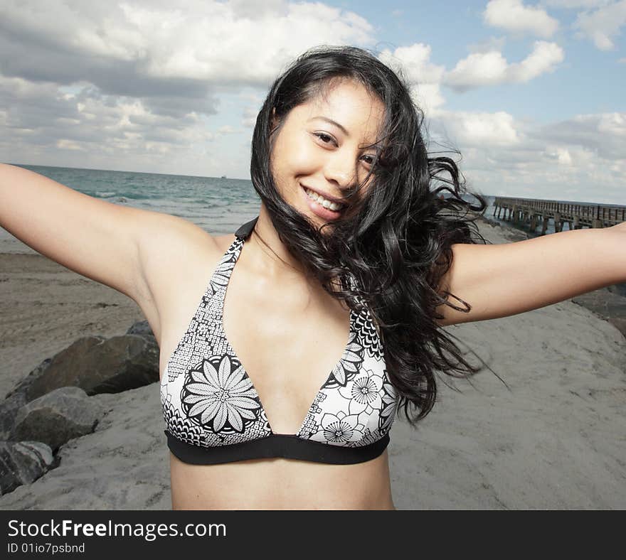 Beautiful young woman smiling with her arms extended outward