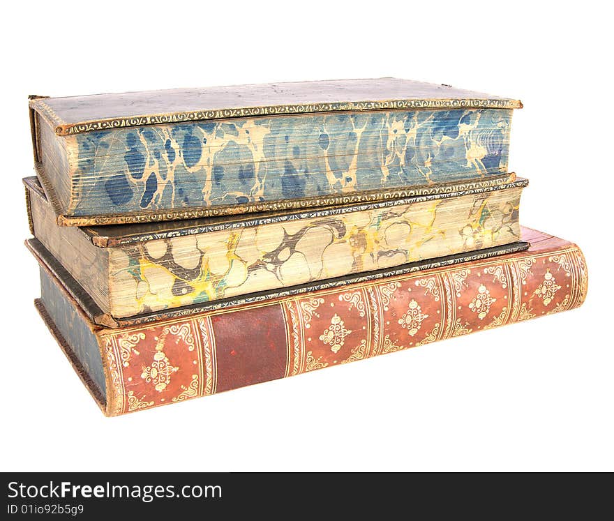 A pile of old leather bound books isolated on a white background