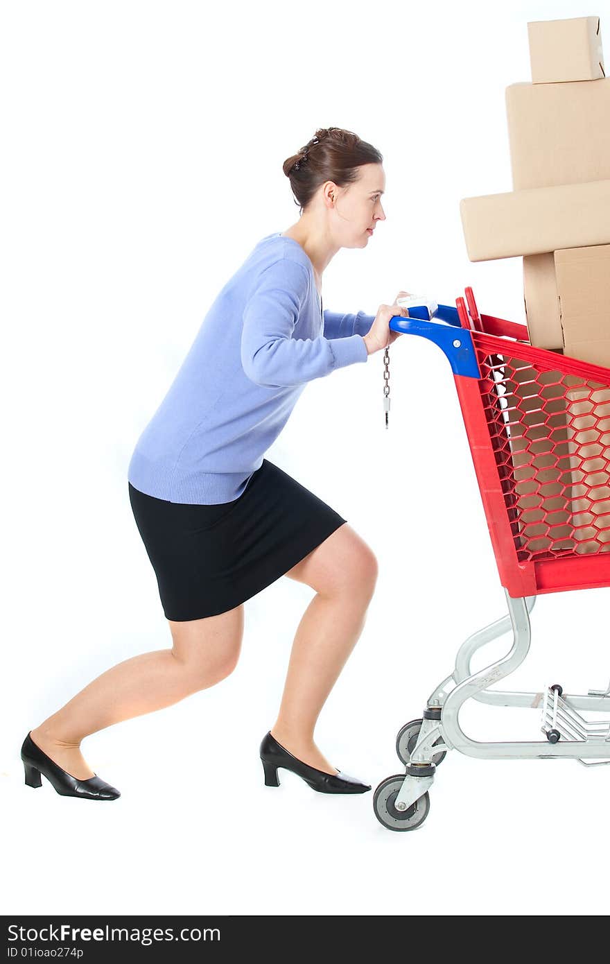 A woman pushing a heavily loaded cart. A woman pushing a heavily loaded cart