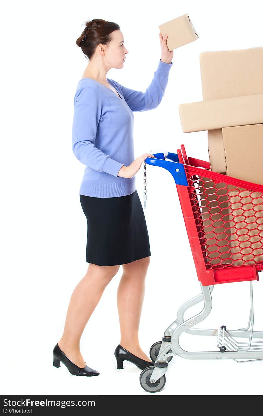 A woman with a shopping trolley full of goods on white. A woman with a shopping trolley full of goods on white