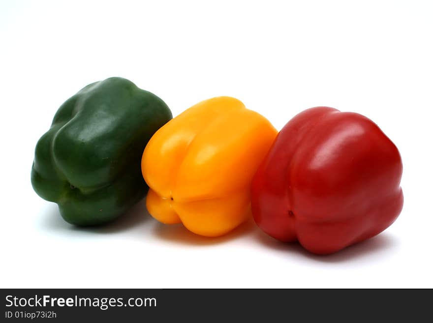 Three  colorful bell peppers.
Isolated on white background. Three  colorful bell peppers.
Isolated on white background.