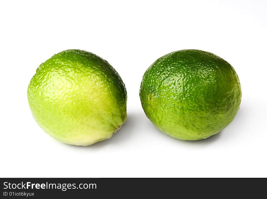 Two fresh lime fruit isolated on white background