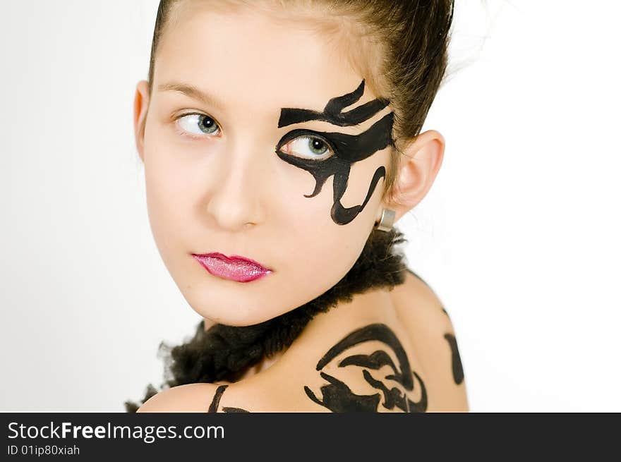 Closeup of girl with black scorpio sign painted on back and face. Closeup of girl with black scorpio sign painted on back and face