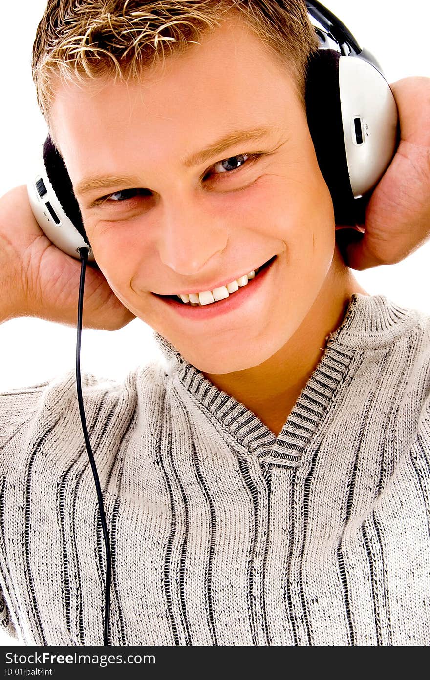 Smiling handsome male listening to music on an isolated background