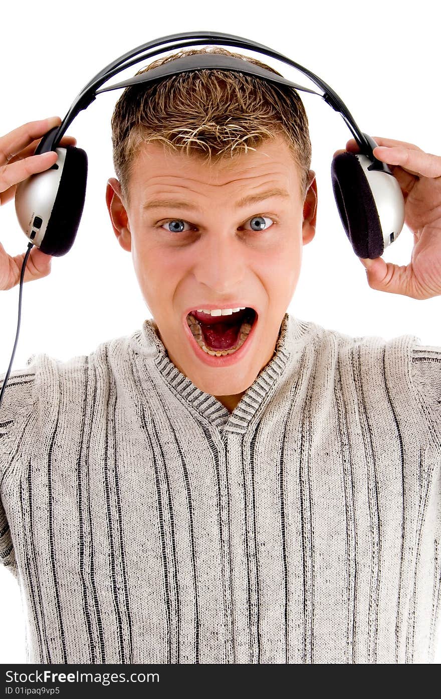 Young man listening to music on an isolated background