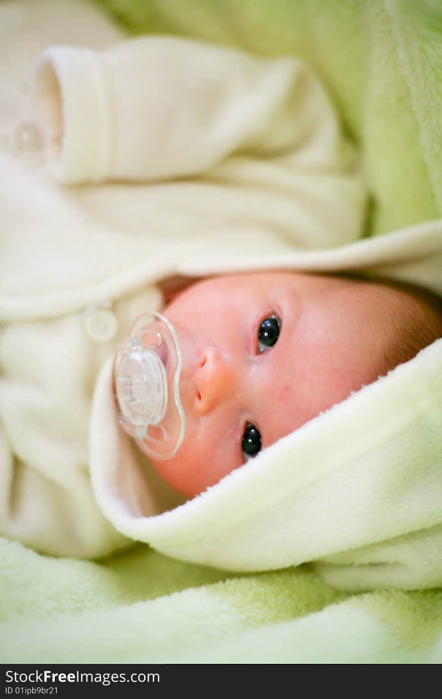 Adorable baby with pacifier in a bad