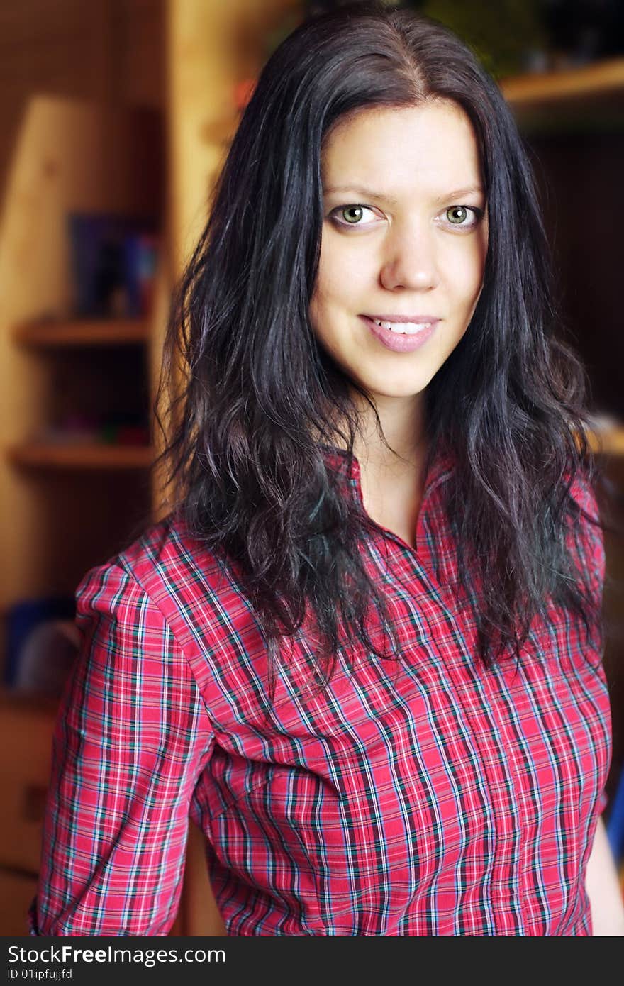 Young woman standing in front of a bookshelf