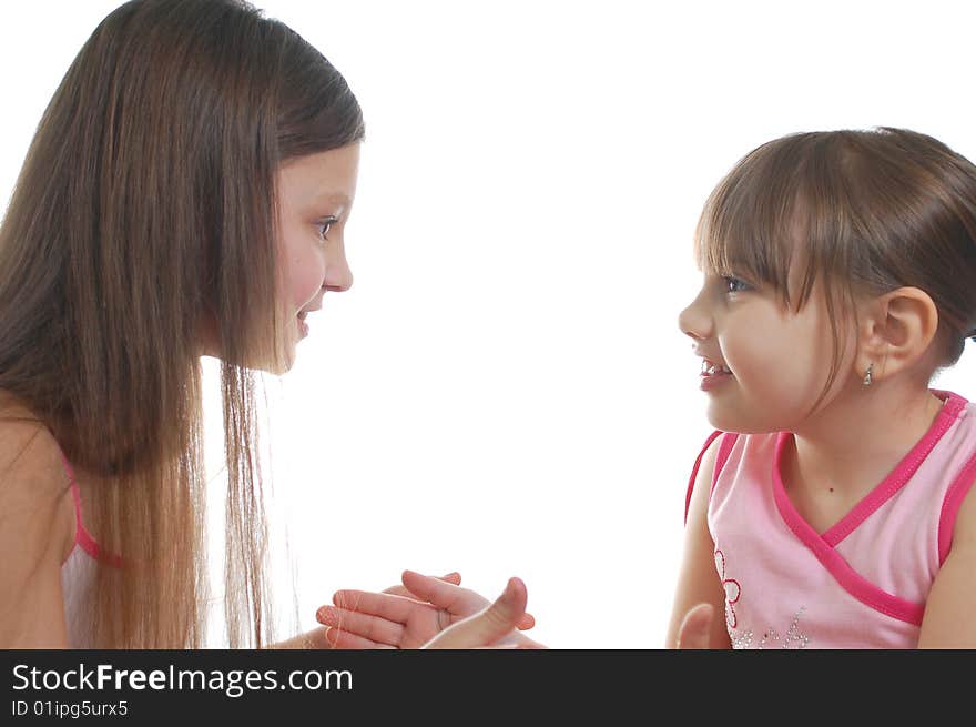 Two young girls isolated on the white background. Two young girls isolated on the white background