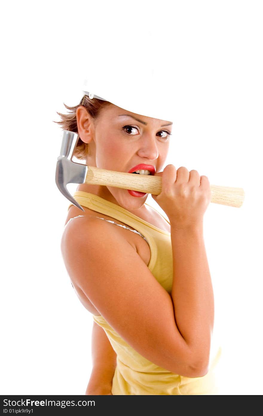 Side view of woman holding hammer with mouth on white background