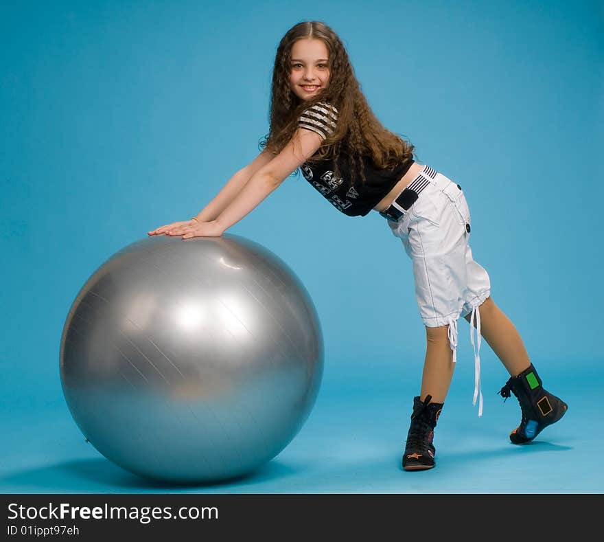 Young girl with a big rubber ball