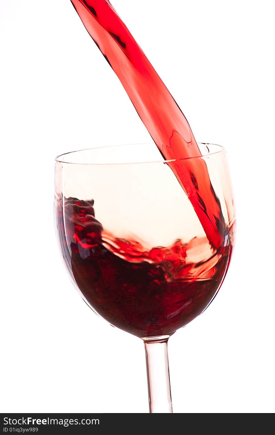 Pour the wine into the glass on a white background