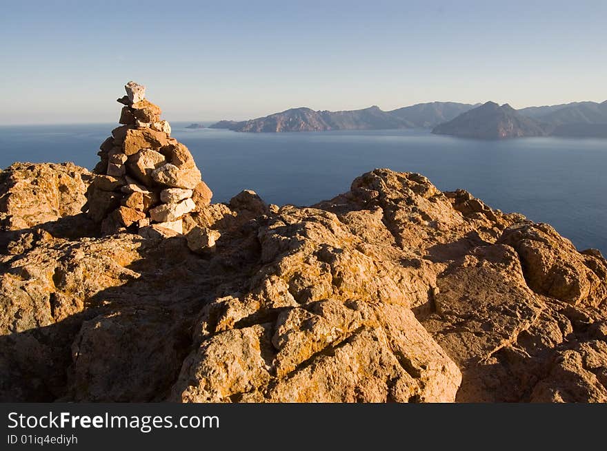 Rock pile on reef on Corsica seashore