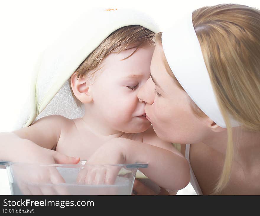 Young mum kisses the child of the boy. Young mum kisses the child of the boy