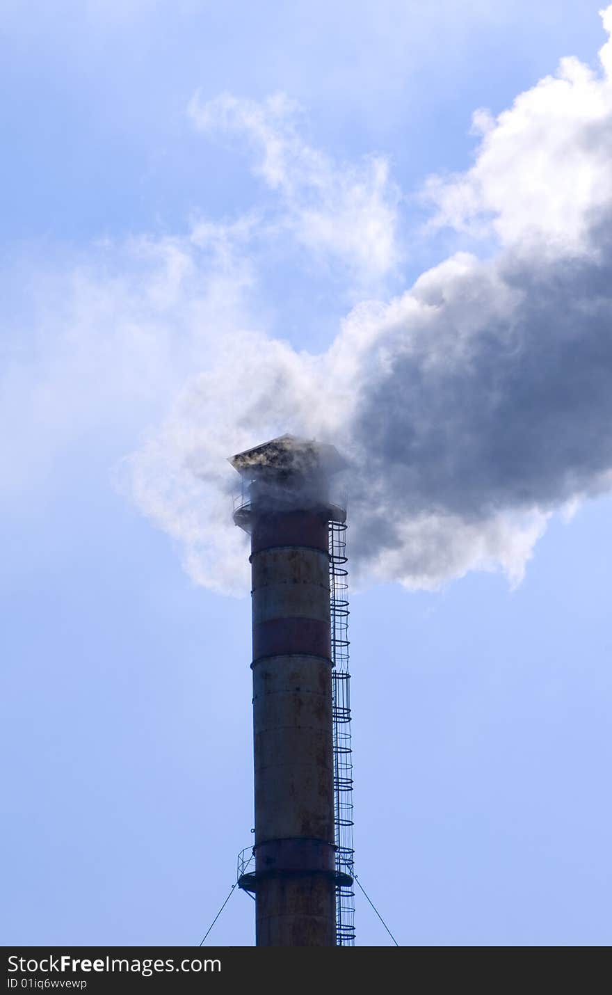 Smoke from pipes on a sky