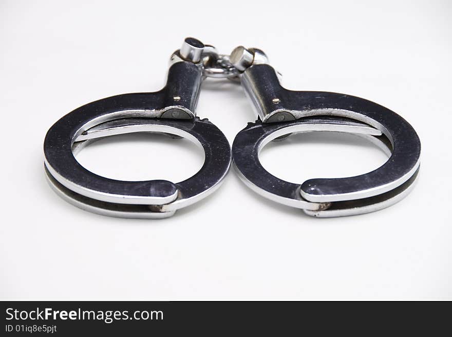 A close-up of handcuff with white background.