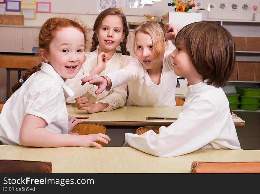 Group of little students with different ages in a classroom. Group of little students with different ages in a classroom