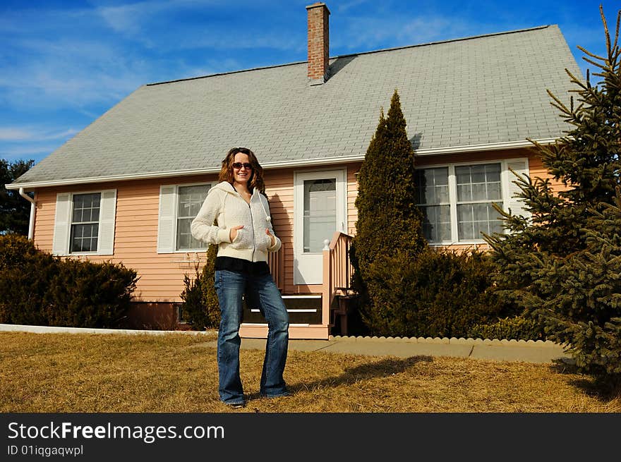 Young woman standing against the house