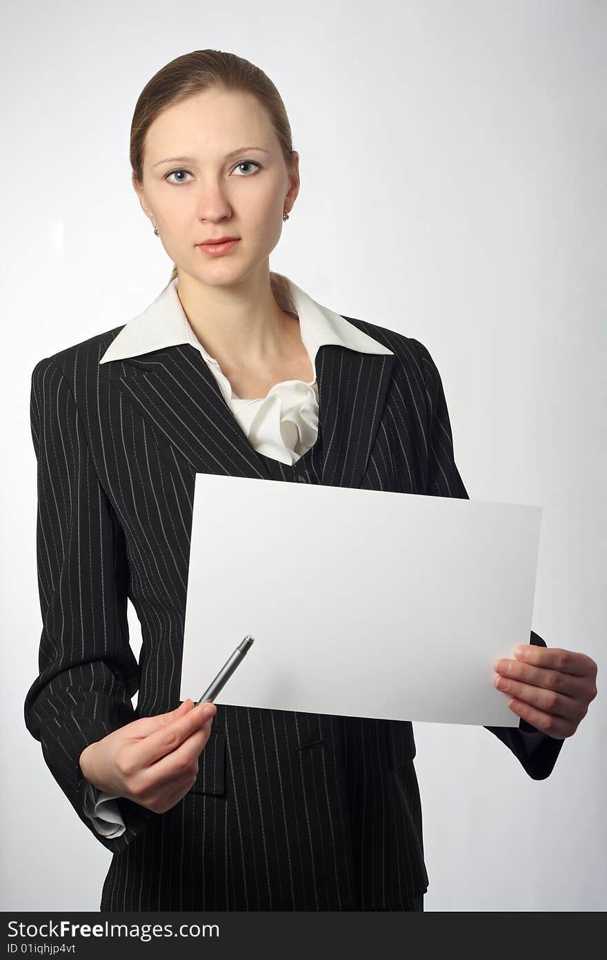 Young beautiful businesswoman with sheet and pen