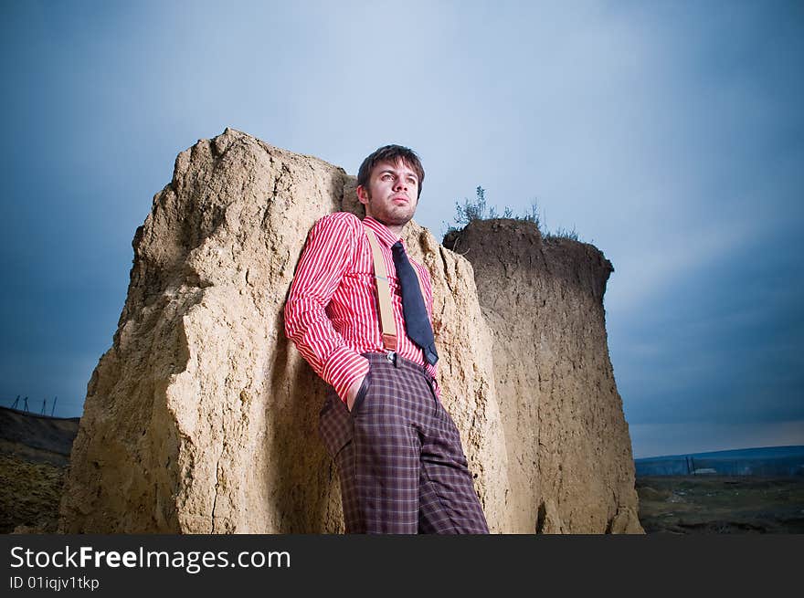 Stylish man outdoors over blue sky background