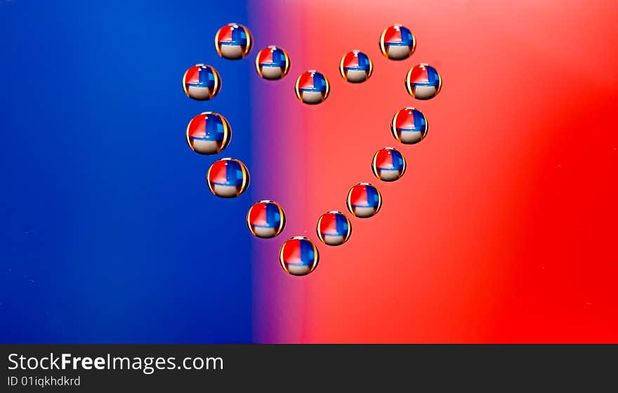 Water drops in the form of heart on a celebratory background