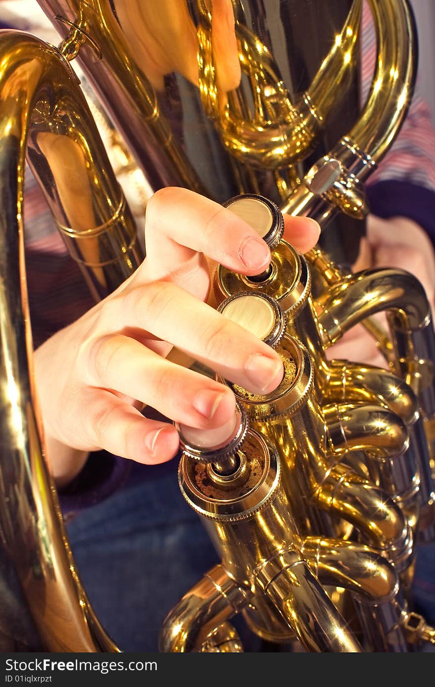 Euphonium being played by a child close up of fingers playing instrument. Euphonium being played by a child close up of fingers playing instrument