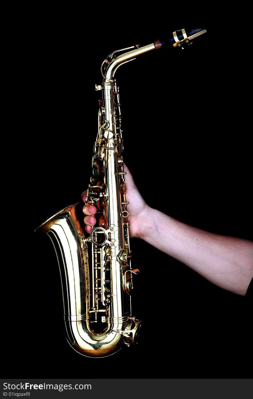 Golden alto saxophone in hands of young man