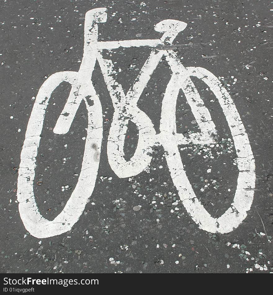 Square composition of painted bicycle sign marking the route for cyclists. Square composition of painted bicycle sign marking the route for cyclists.