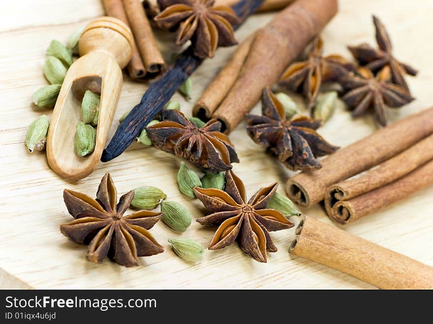 Cinnamon Sticks,Cardamom,vanilla bean and star anise on white - tight depth of field