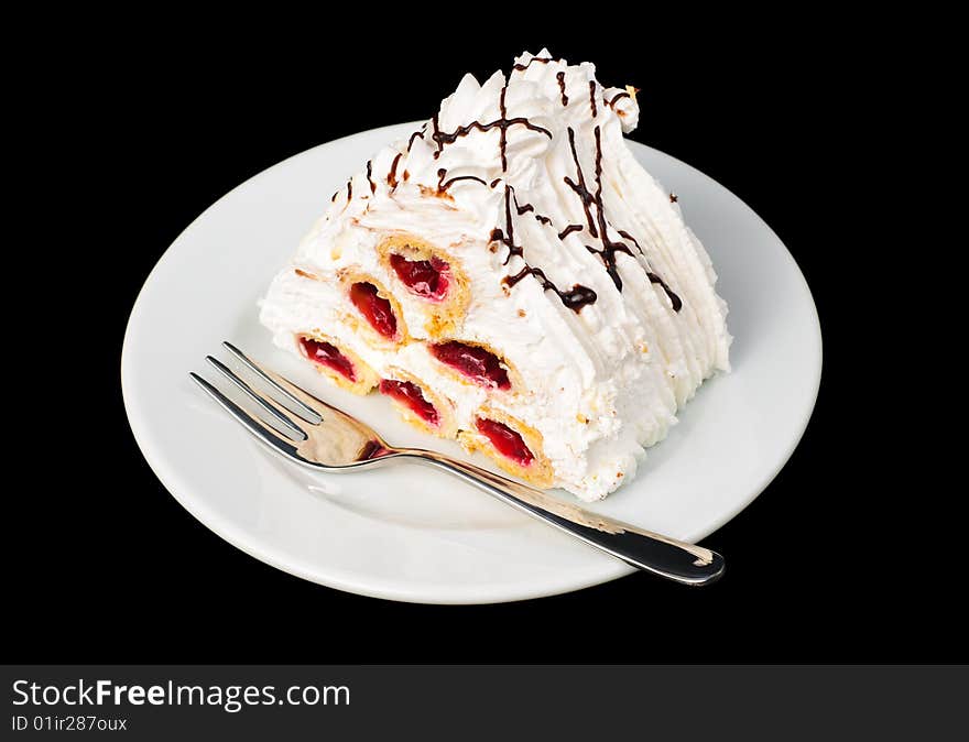 Piece of fancy cherry pyramid tart on plate, isolated on black. Piece of fancy cherry pyramid tart on plate, isolated on black