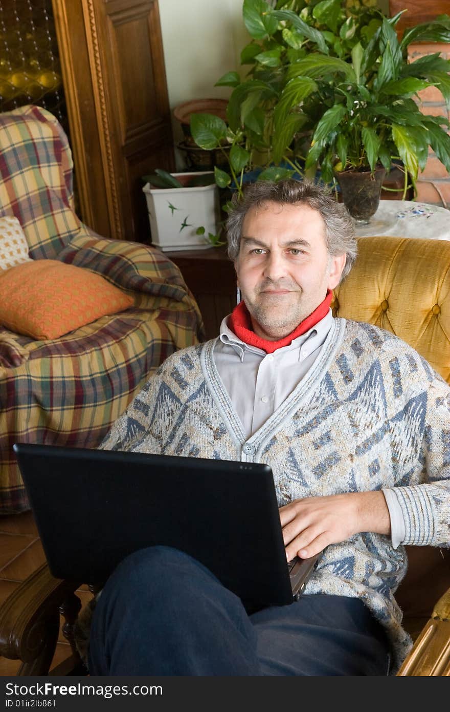 An mid age man at work with his computer at home