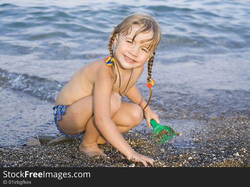 Pretty and cheerful little girl  have a fun and swim in the swimming-pool. Pretty and cheerful little girl  have a fun and swim in the swimming-pool