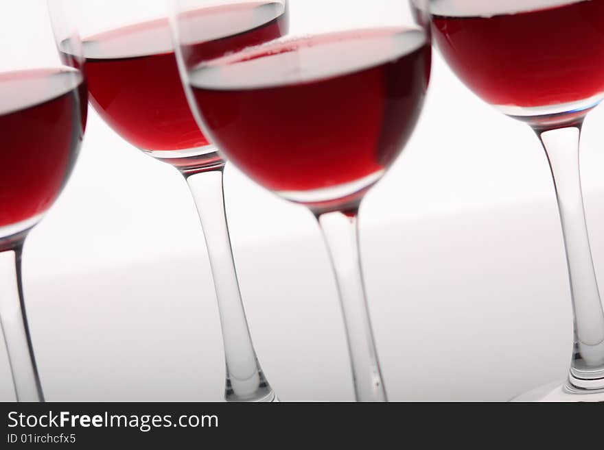 Glasses of red wine over white background. Glasses of red wine over white background.