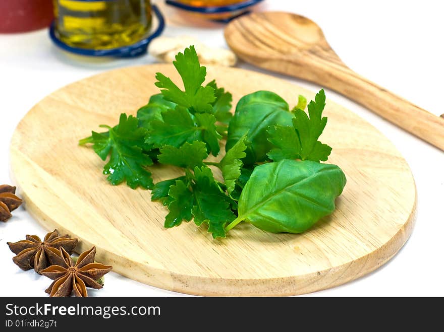 Fresh basil on the wooden cutting board.