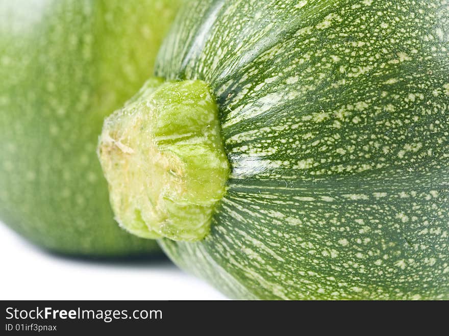 Two globe zucchini isolated on white.