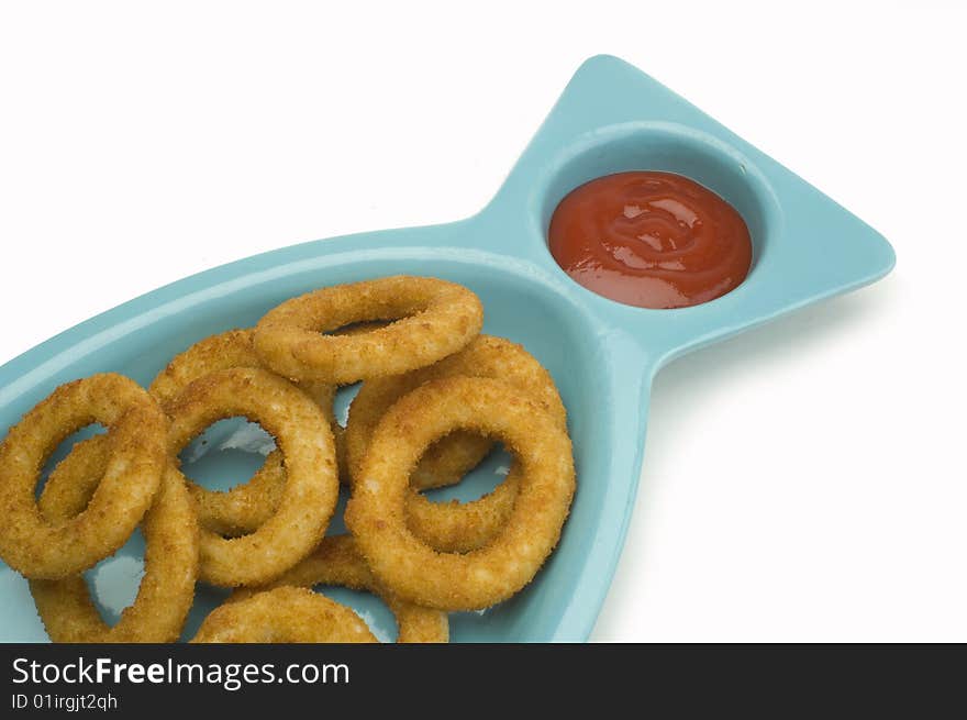 An order of onion rings with ketchup on white