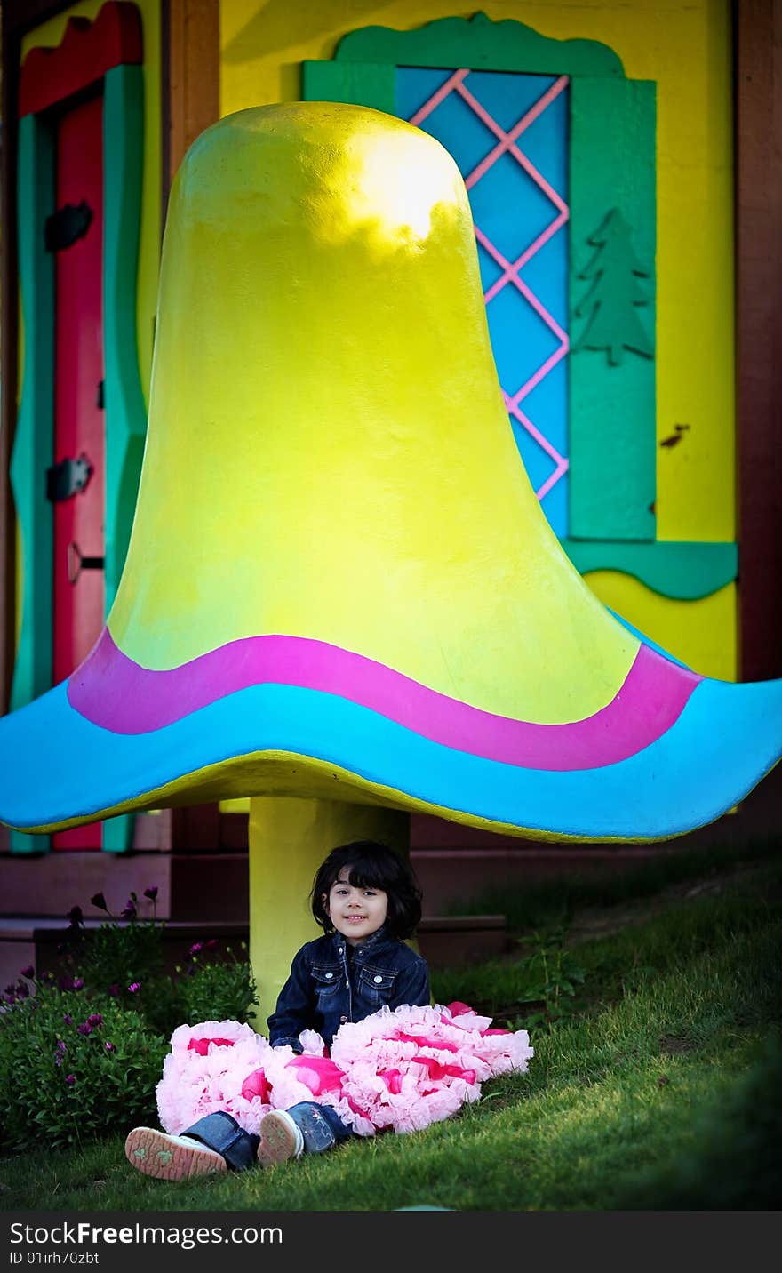 Fairytale place with lots of flowers and a big mushroom.