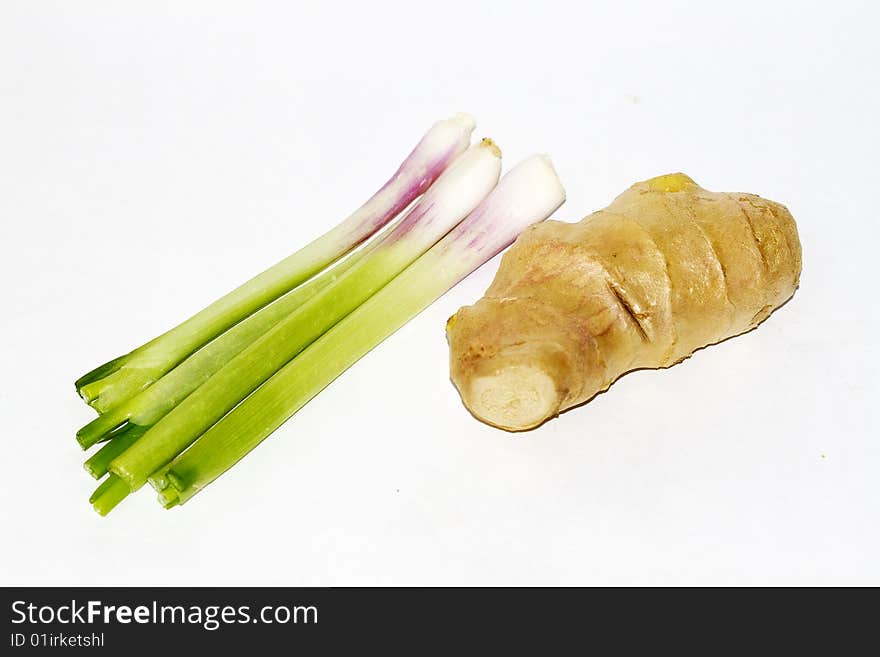 Some onions and ginger over white background.