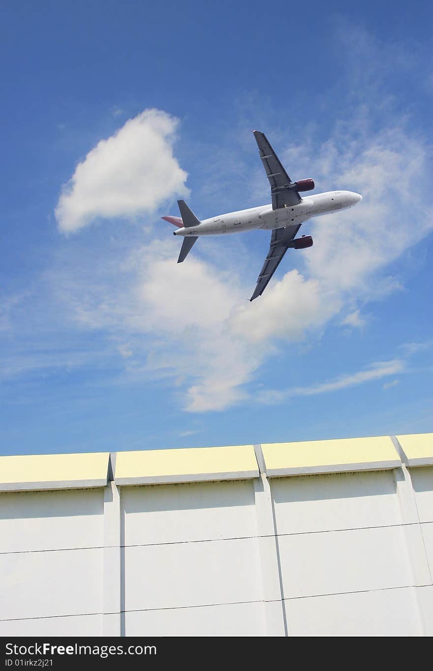 The airplane on  the blue sky background. The airplane on  the blue sky background.