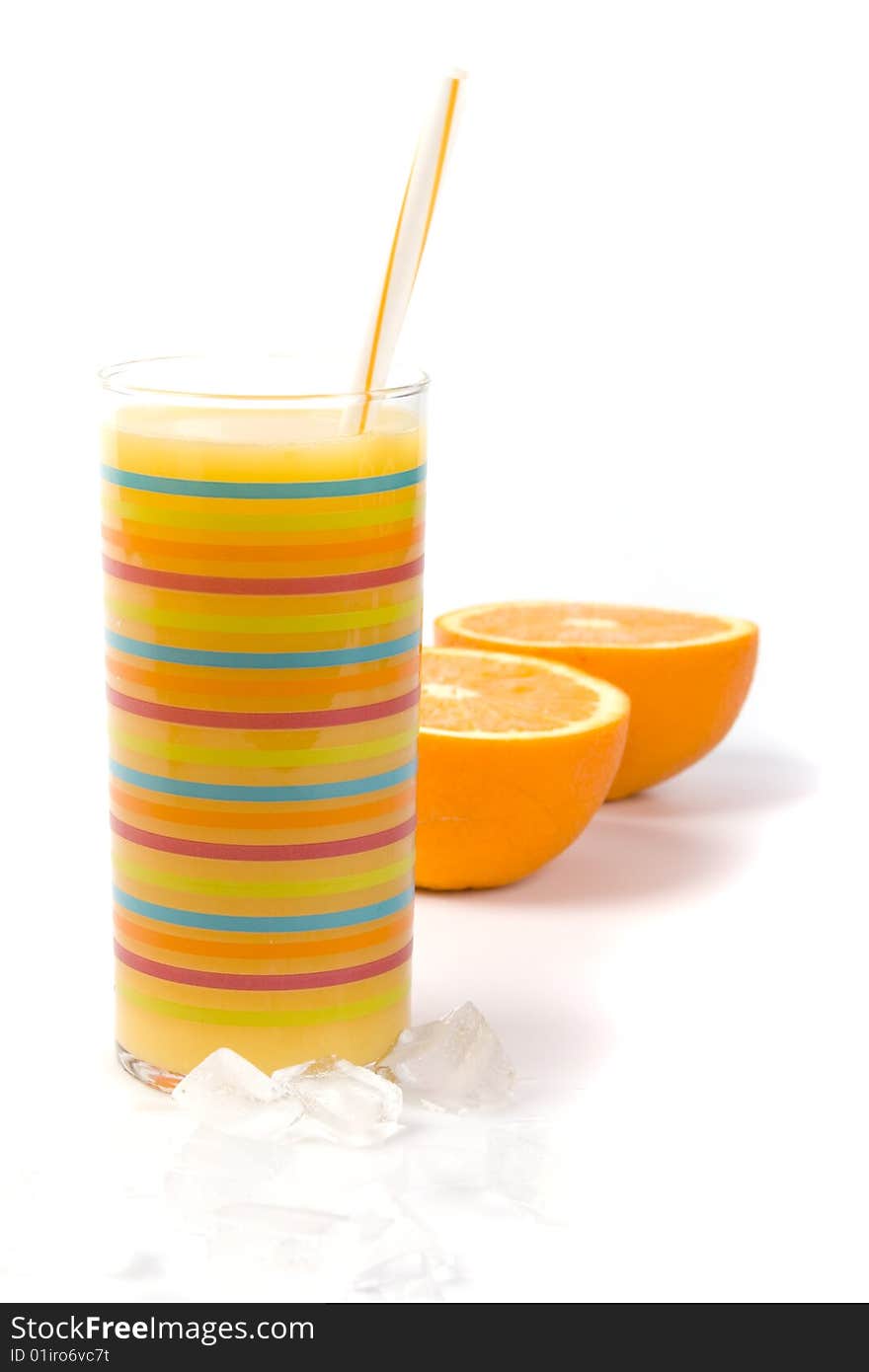 Oranges, ice and juice in glass on white