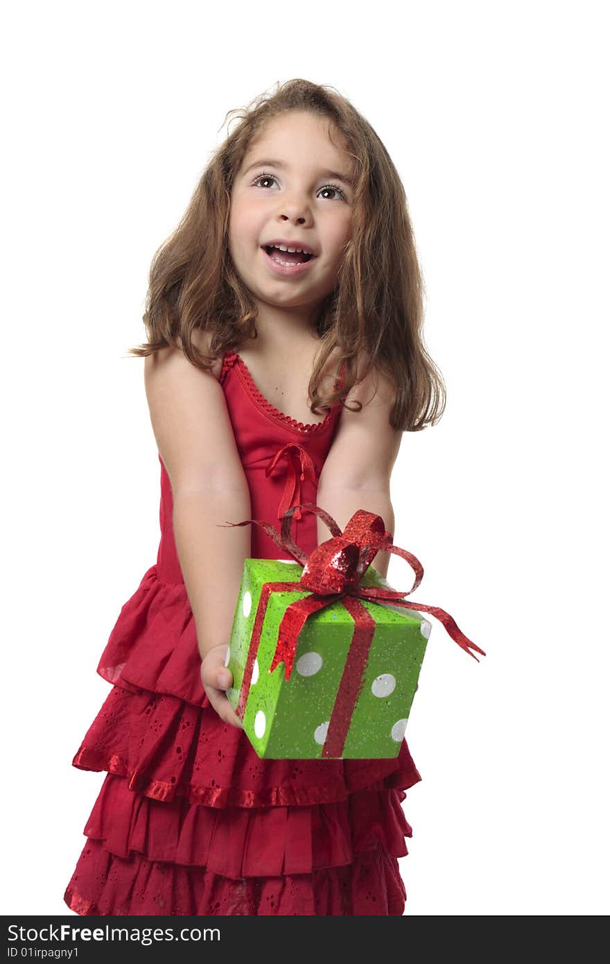 Young child holding a present with a gleeful smile. Young child holding a present with a gleeful smile.