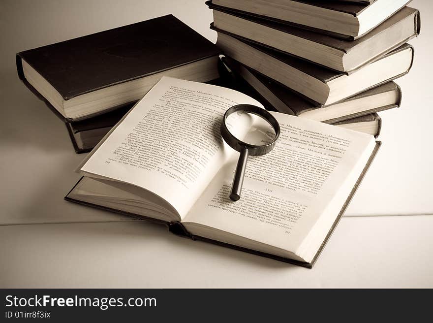 Books on the table. Isolated over black background