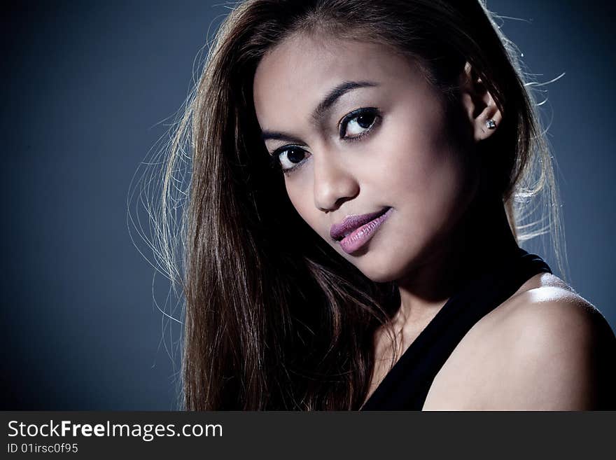 Portrait of mysterious young woman smile with dark background. Portrait of mysterious young woman smile with dark background