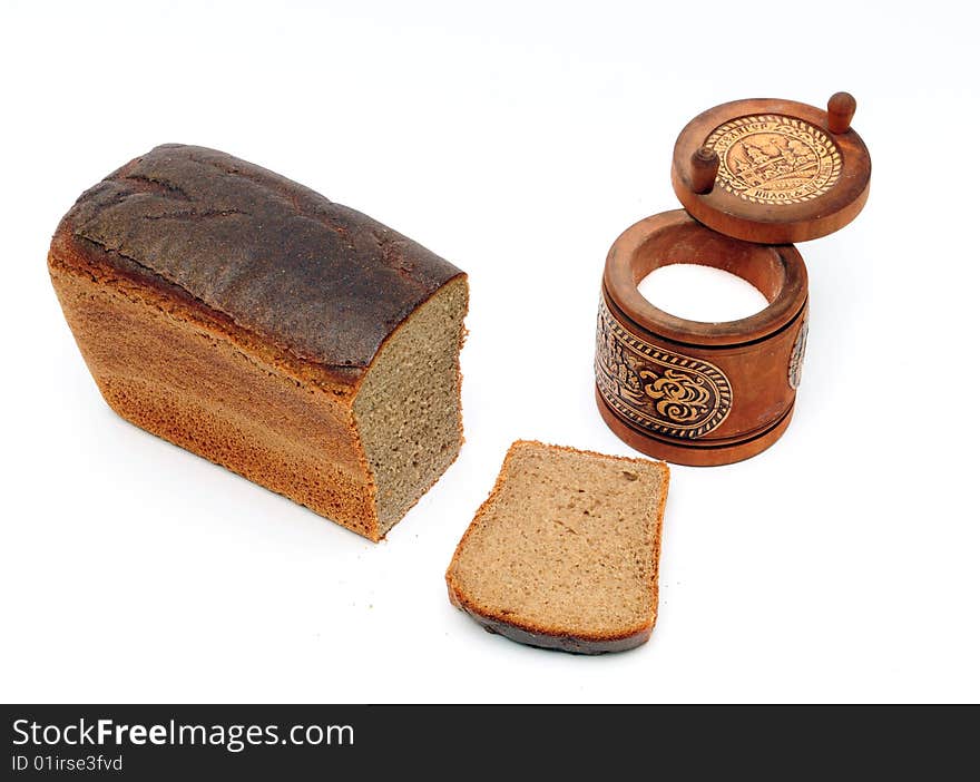 Loaf of bread and saltcellar on the white background